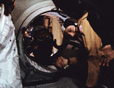 Photo of Astronaut Thomas P. Stafford and cosmonaut Alexei Leonov shake hands in space during Apollo–Soyuz